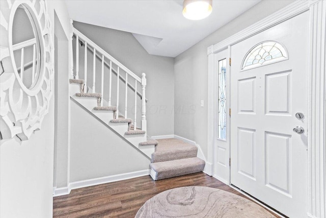 entrance foyer with baseboards, stairway, and wood finished floors