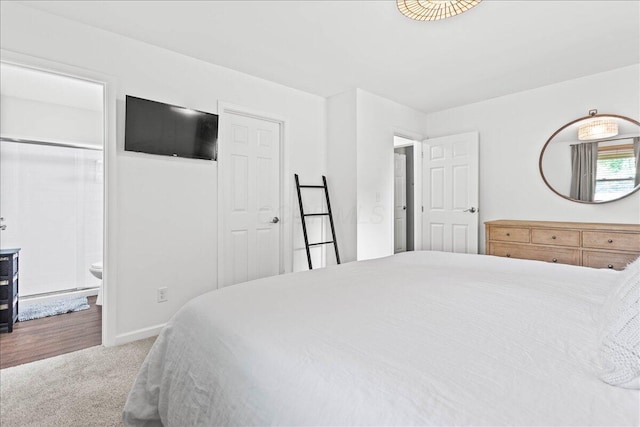 bedroom with carpet, connected bathroom, and baseboards