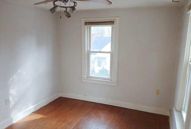 empty room with baseboards, light wood-style floors, and a ceiling fan