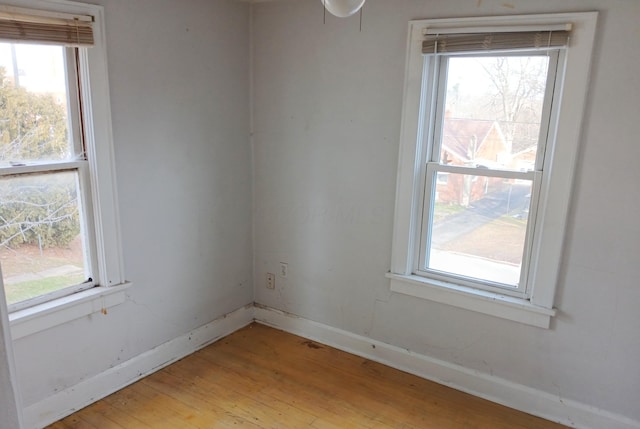 empty room with light wood-type flooring and baseboards