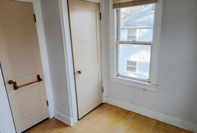 unfurnished bedroom with light wood-style floors and baseboards