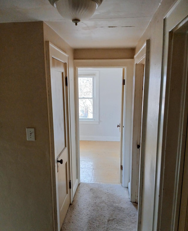 hallway featuring baseboards