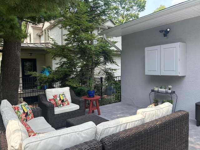 view of patio / terrace featuring an outdoor living space and fence