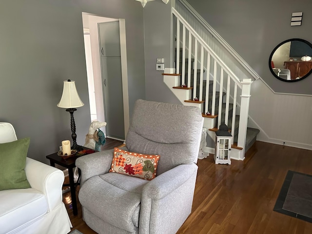 living room featuring stairs, wood finished floors, and baseboards