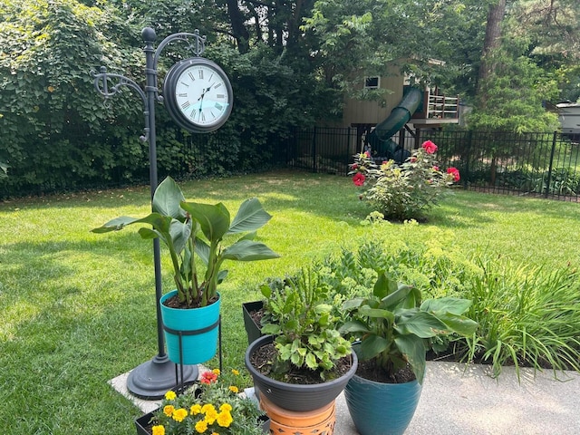 view of yard featuring fence and a playground