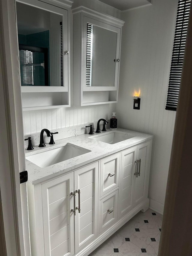 bathroom with double vanity and a sink