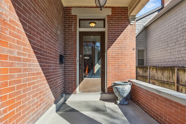 property entrance with brick siding