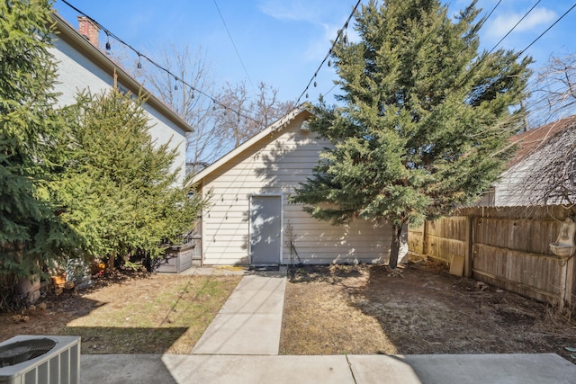 view of yard featuring central AC unit and fence