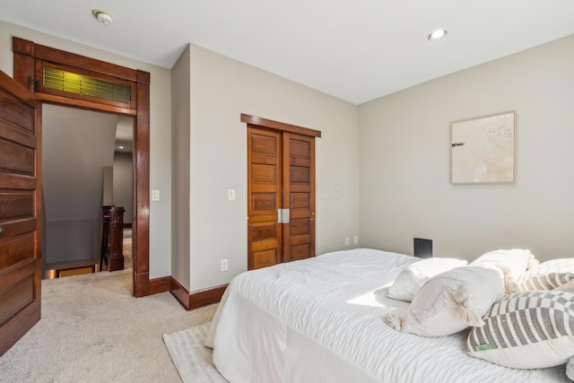 bedroom with light carpet, recessed lighting, a closet, and baseboards