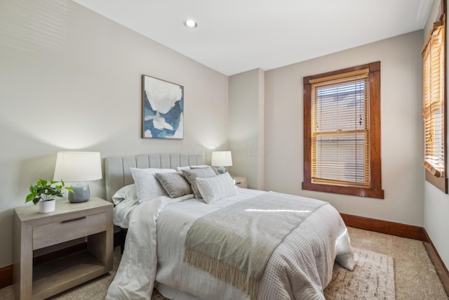 bedroom with recessed lighting, baseboards, and multiple windows