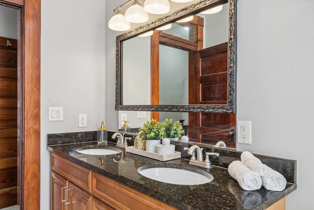 bathroom with a sink and double vanity