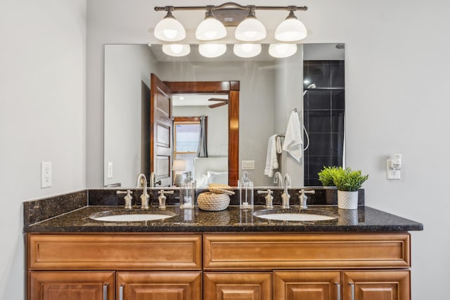 bathroom with double vanity, a ceiling fan, and a sink