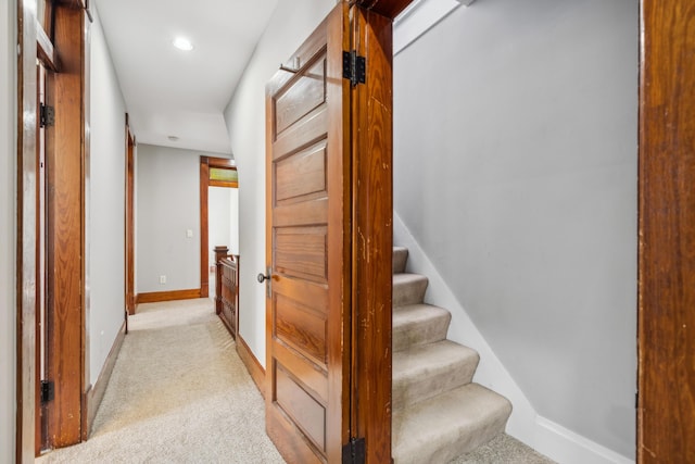 corridor featuring light carpet, stairway, recessed lighting, and baseboards