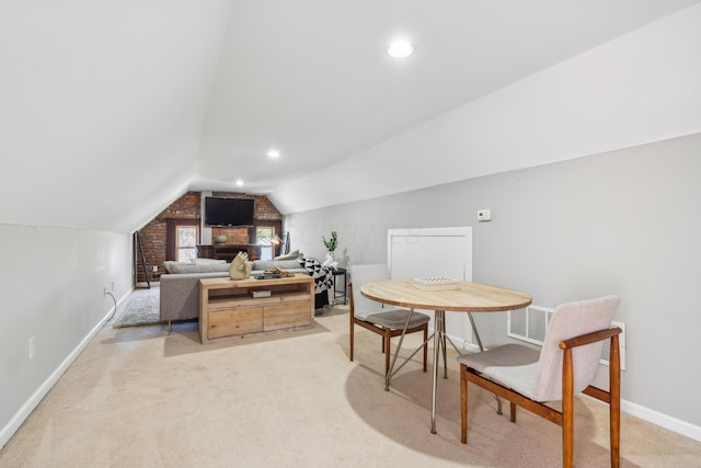 interior space with light carpet, visible vents, baseboards, and vaulted ceiling