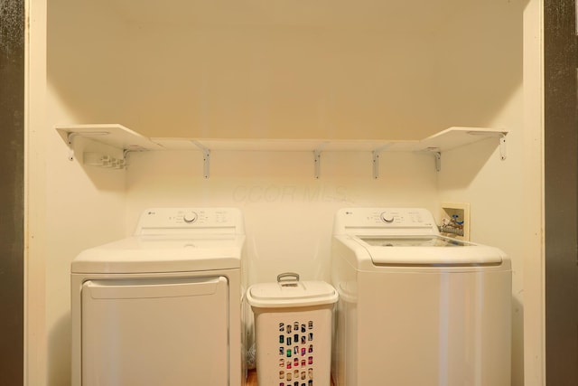 clothes washing area with laundry area and washer and dryer