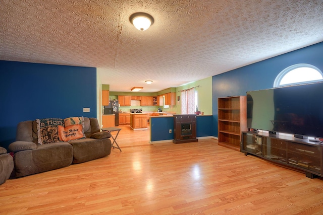 living room featuring light wood-style flooring and a textured ceiling