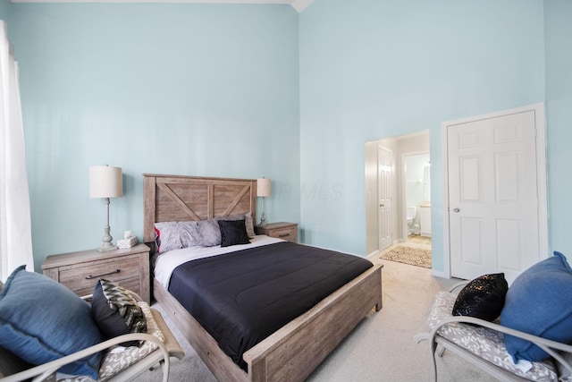 bedroom featuring a high ceiling and carpet