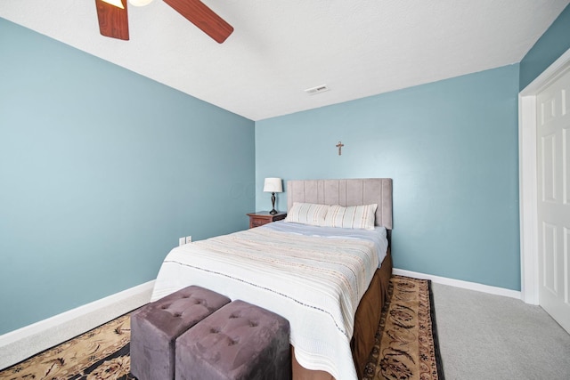 bedroom with carpet flooring, ceiling fan, visible vents, and baseboards