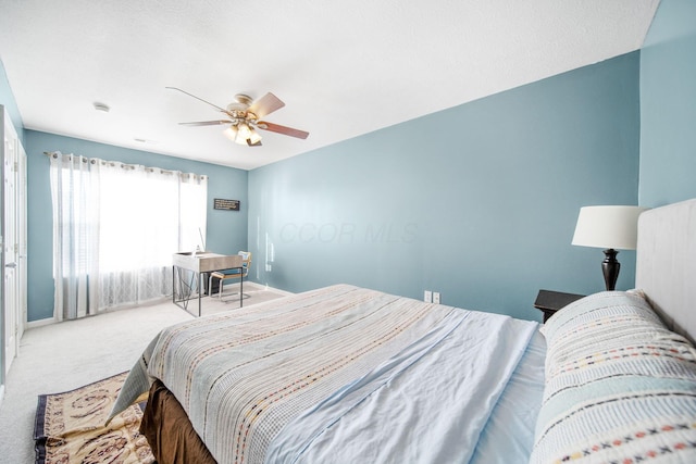 bedroom featuring baseboards, a ceiling fan, and carpet floors