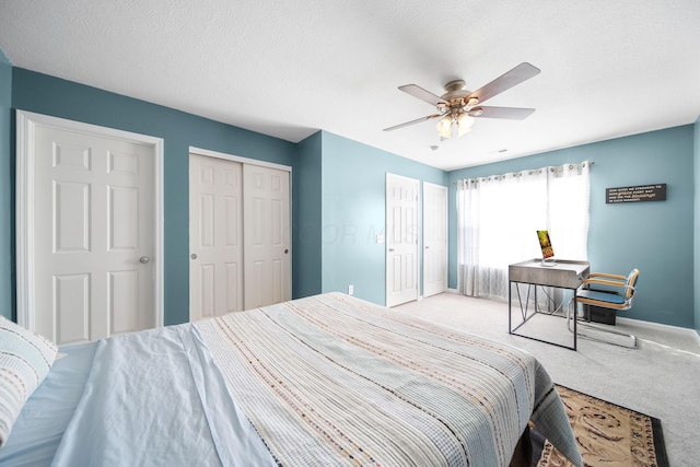 bedroom with a ceiling fan, a textured ceiling, a closet, carpet floors, and baseboards