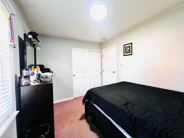 carpeted bedroom featuring baseboards