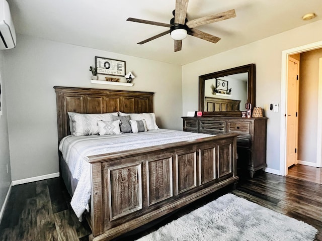 bedroom featuring a wall unit AC, baseboards, dark wood-style flooring, and ceiling fan