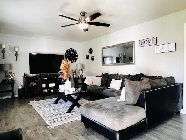 living room with wood finished floors and a ceiling fan