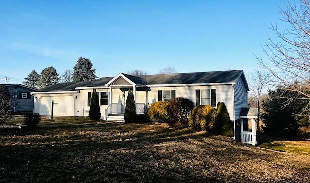 single story home with a front yard and an attached garage