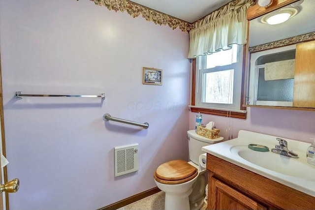 bathroom featuring visible vents, toilet, and vanity