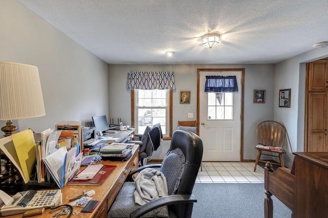 office area featuring light tile patterned flooring and a textured ceiling