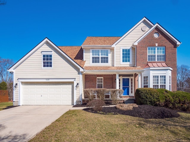 traditional home with a front yard, roof with shingles, concrete driveway, a garage, and brick siding