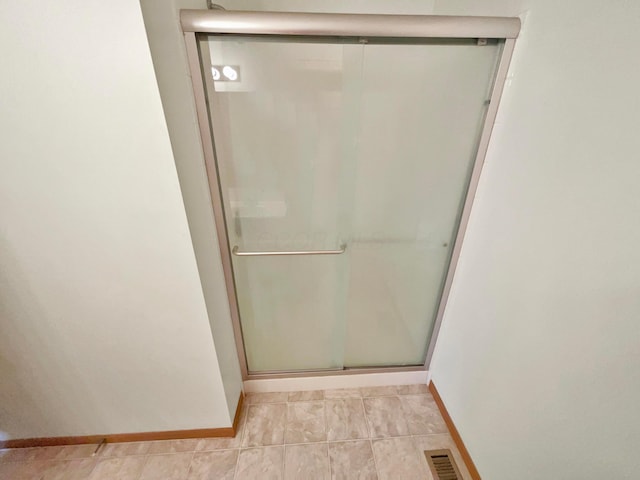 full bath with visible vents, baseboards, a stall shower, and tile patterned flooring