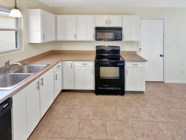 kitchen featuring black appliances, white cabinets, and a sink