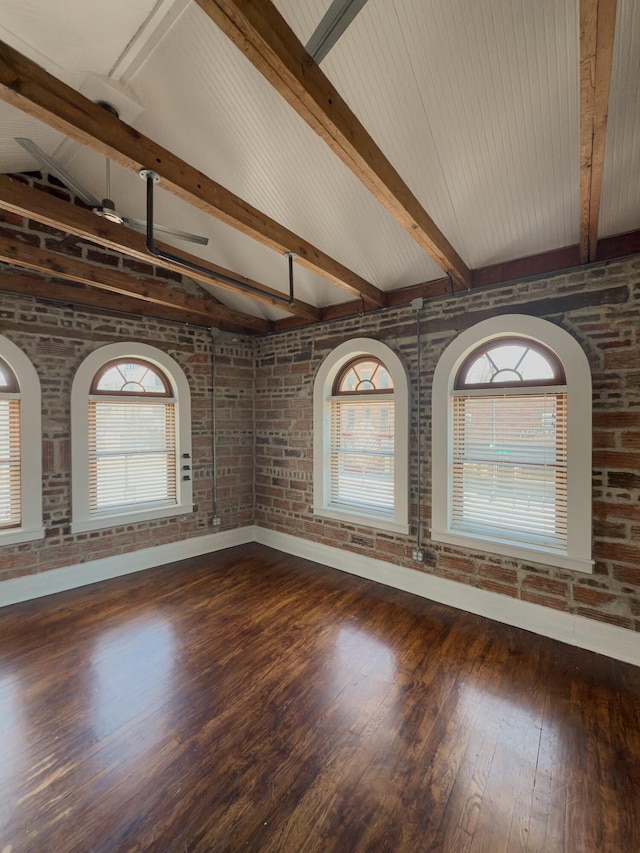 unfurnished room featuring hardwood / wood-style floors, vaulted ceiling with beams, baseboards, and brick wall