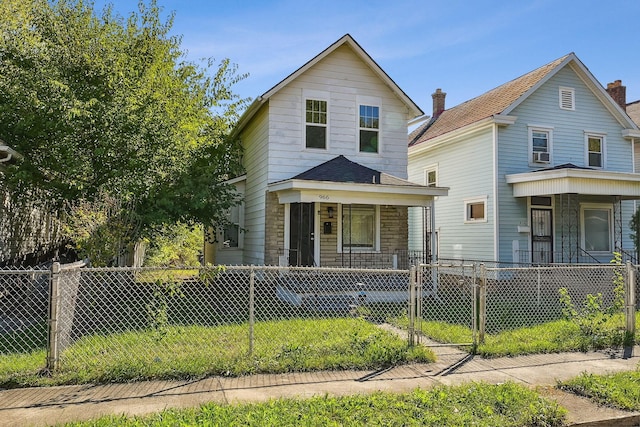 view of front of home featuring a gate, covered porch, and a fenced front yard