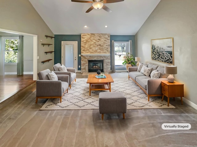 living area featuring baseboards, high vaulted ceiling, wood finished floors, and a ceiling fan