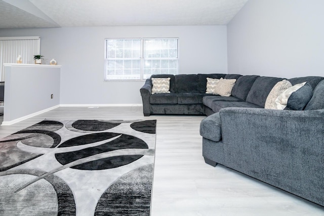 living area with wood finished floors and baseboards