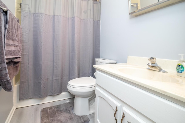 full bathroom with shower / tub combo with curtain, toilet, wood finished floors, and vanity