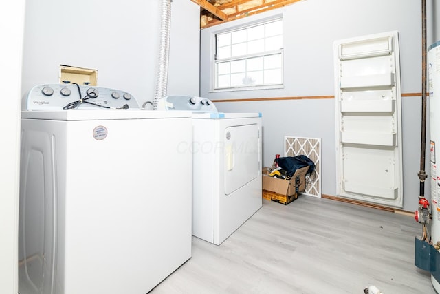 laundry room with separate washer and dryer, light wood-style flooring, and laundry area