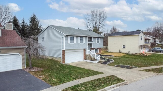 bi-level home featuring concrete driveway and a front yard