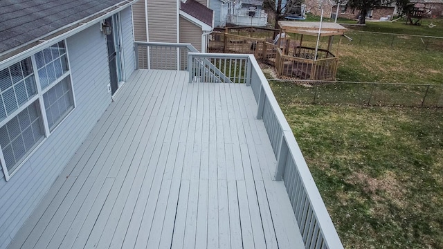 wooden terrace with a yard and a fenced backyard