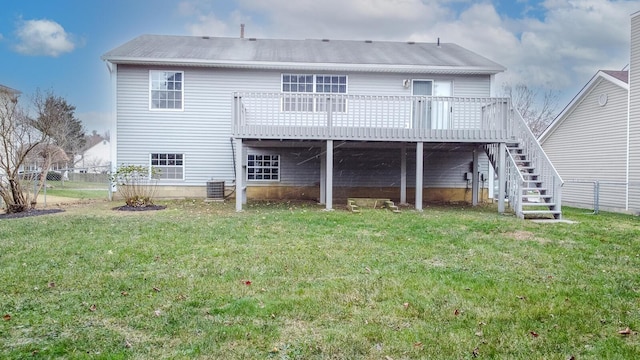 back of house featuring stairs, a lawn, and fence