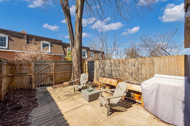 view of patio featuring a grill and a fenced backyard