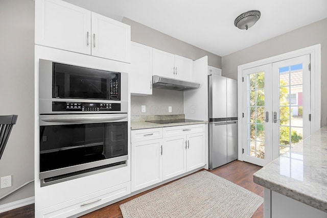 kitchen with black appliances, white cabinets, french doors, and under cabinet range hood