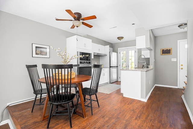 dining room with french doors, a ceiling fan, baseboards, and dark wood-style flooring