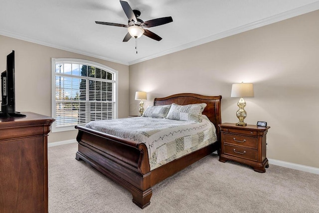 carpeted bedroom with a ceiling fan, baseboards, and ornamental molding