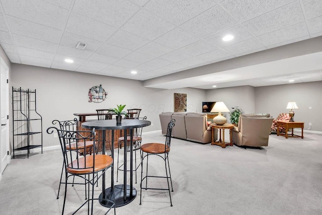 dining area featuring recessed lighting, a drop ceiling, baseboards, and light colored carpet