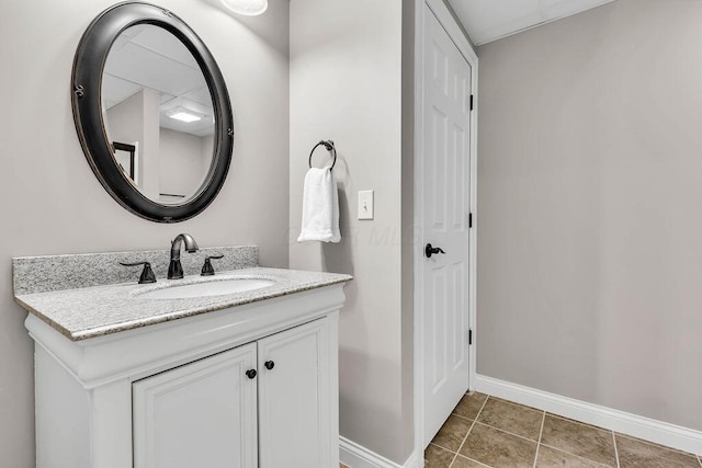 bathroom with tile patterned flooring, vanity, and baseboards