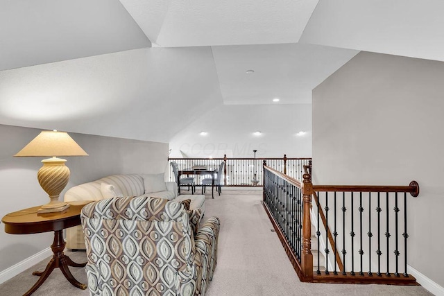 sitting room with vaulted ceiling, baseboards, and carpet floors