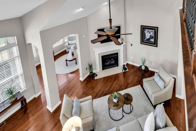 living area with a fireplace with flush hearth, wood finished floors, and plenty of natural light